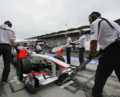 Photos show Sauber with UBS sponsor logos